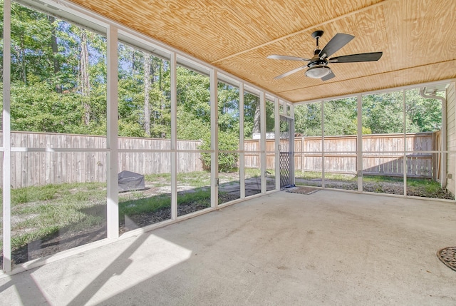 unfurnished sunroom with ceiling fan and wooden ceiling