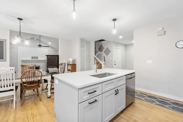 kitchen featuring a sink, light wood-type flooring, dishwasher, and ceiling fan