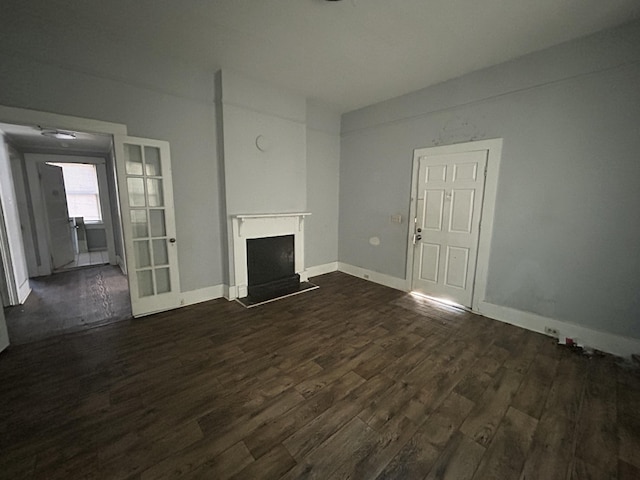 unfurnished living room featuring french doors and dark hardwood / wood-style floors