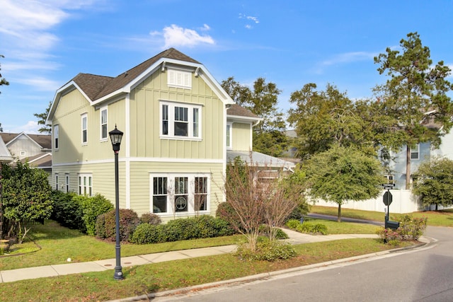 view of side of home with a yard