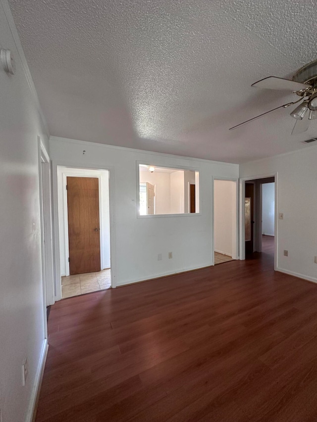 spare room featuring a textured ceiling, ceiling fan, and light wood-type flooring