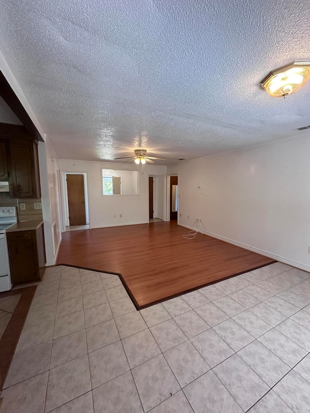 tiled spare room featuring ceiling fan and a textured ceiling