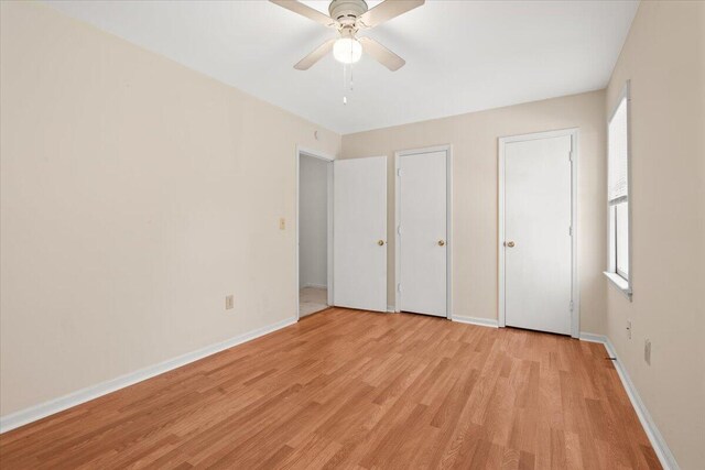 1383 Camp Rd Unit C, Charleston, SC 29412 - unfurnished bedroom with light wood-style flooring, two closets, and ceiling fan
