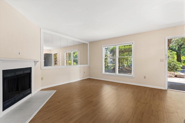 1383 Camp Rd Unit C, Charleston, SC 29412 - unfurnished living room featuring a tiled fireplace and wood-type flooring