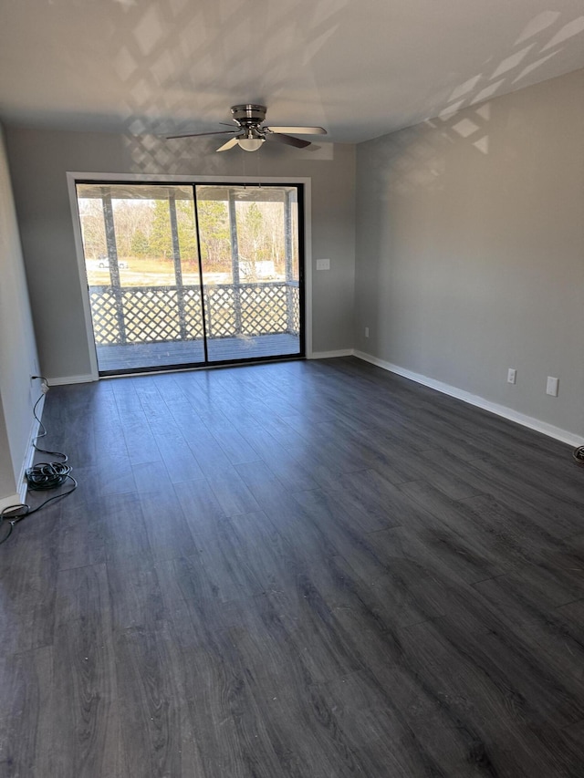 unfurnished room with ceiling fan and dark hardwood / wood-style flooring