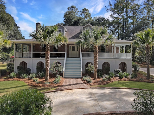 102 Flud St, Summerville, SC 29483 - view of front facade with a porch, stairs, a chimney, brick siding, and roof with shingles