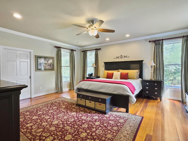 bedroom with ceiling fan, crown molding, and hardwood / wood-style floors