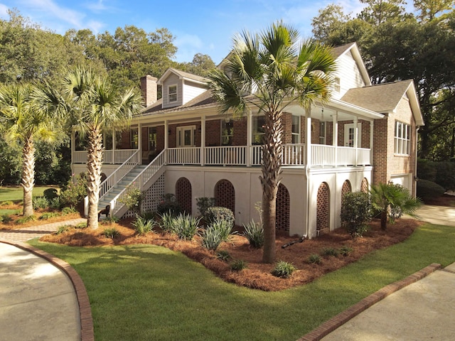 view of front of house with covered porch and a front yard