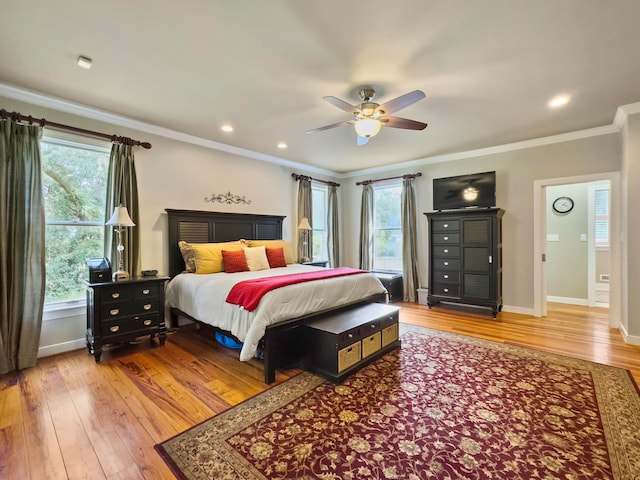 bedroom featuring ceiling fan, wood-type flooring, and crown molding