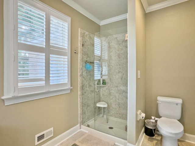 bathroom with toilet, crown molding, and walk in shower