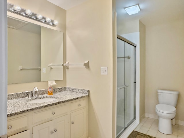 bathroom featuring walk in shower, vanity, tile patterned flooring, and toilet