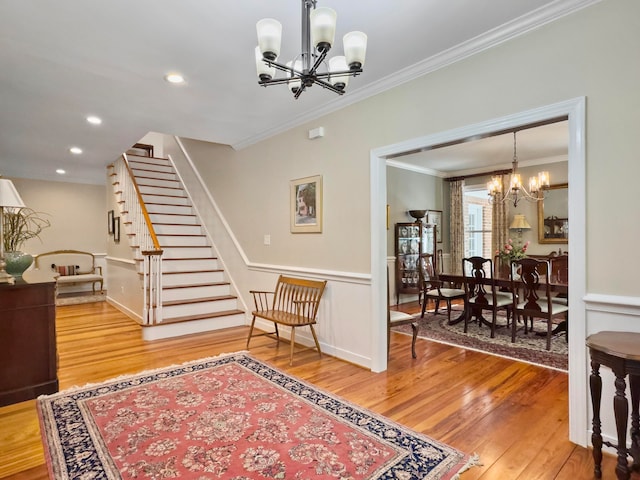 interior space with an inviting chandelier, crown molding, and wood-type flooring