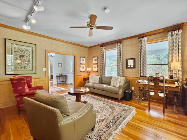 living room with ceiling fan, crown molding, hardwood / wood-style flooring, and track lighting