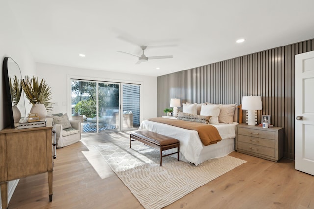 bedroom with light hardwood / wood-style floors, ceiling fan, and access to outside