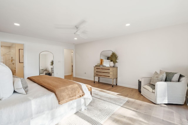 bedroom featuring ensuite bathroom, ceiling fan, and light hardwood / wood-style flooring