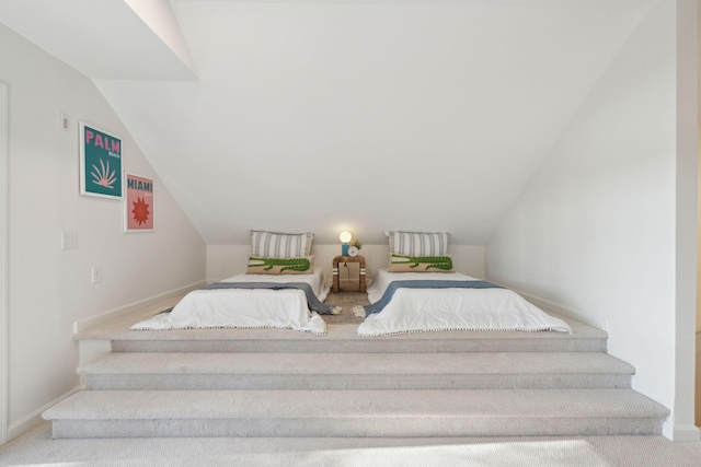 carpeted bedroom featuring vaulted ceiling