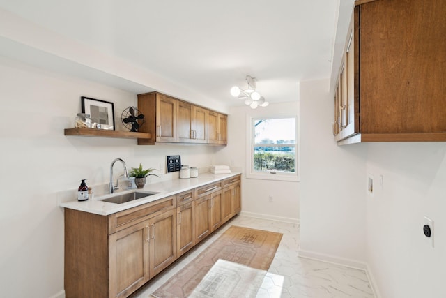 kitchen featuring sink and a notable chandelier