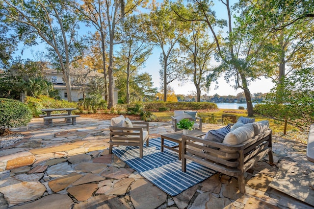 view of patio / terrace with an outdoor living space and a water view