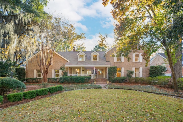 view of front facade with a front yard and a porch