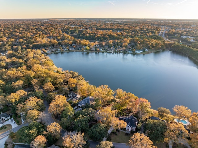 aerial view at dusk featuring a water view