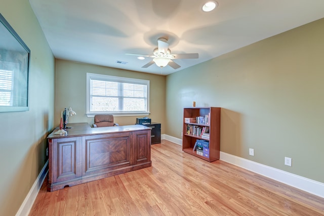 office space featuring ceiling fan and light hardwood / wood-style floors