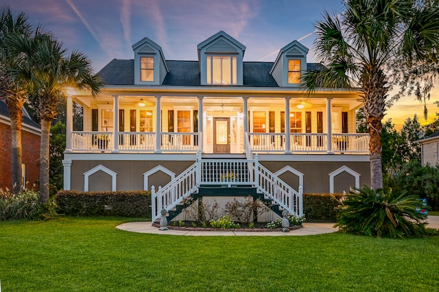 view of front of house featuring a lawn and covered porch