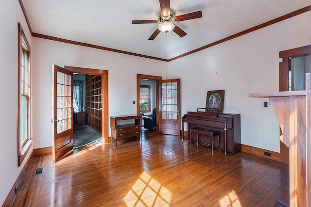 interior space with visible vents, baseboards, wood-type flooring, ornamental molding, and french doors