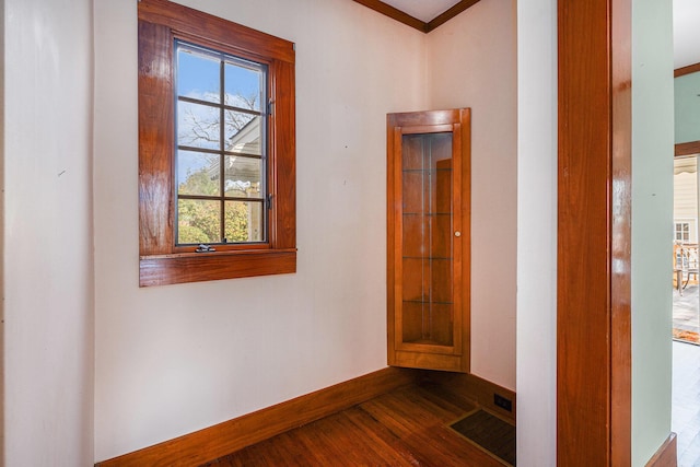 corridor with baseboards and dark wood finished floors