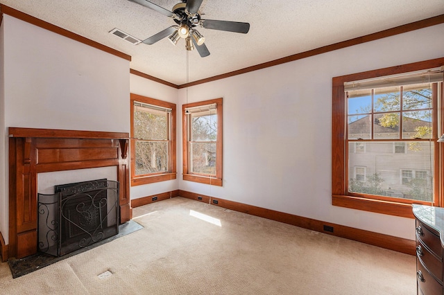 unfurnished living room featuring a textured ceiling, carpet floors, a fireplace with flush hearth, and visible vents