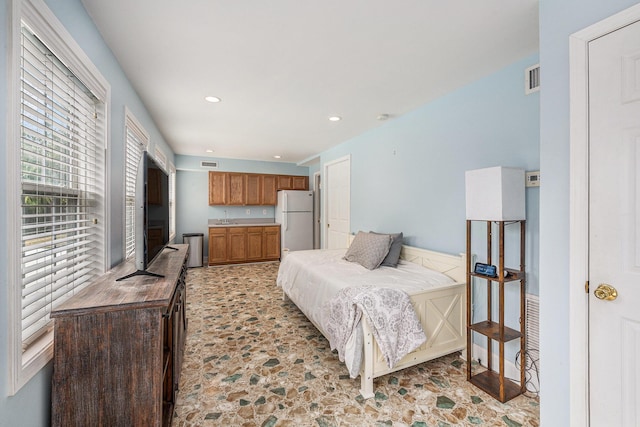 bedroom featuring recessed lighting, visible vents, a sink, and freestanding refrigerator