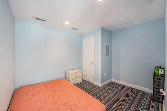 bedroom with dark colored carpet, visible vents, baseboards, and recessed lighting