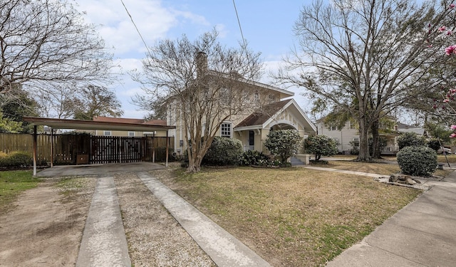 view of front of home with driveway, a front lawn, and fence