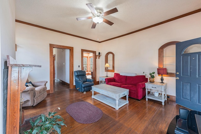 living area featuring a textured ceiling, ceiling fan, wood-type flooring, and arched walkways