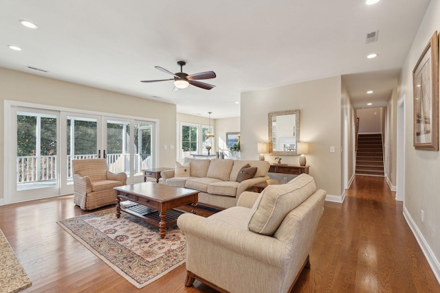 living area featuring recessed lighting, visible vents, and wood finished floors