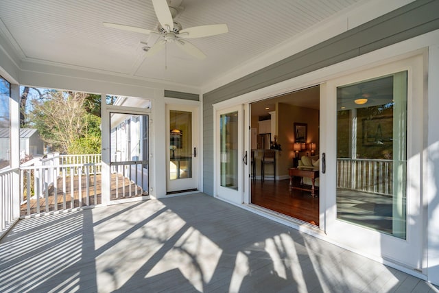 unfurnished sunroom with a ceiling fan