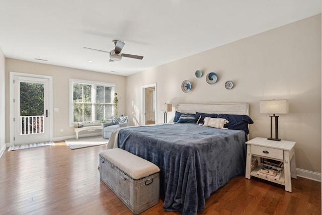 bedroom featuring dark wood-type flooring, access to exterior, and baseboards