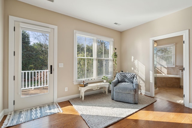 doorway to outside featuring plenty of natural light, wood finished floors, and visible vents