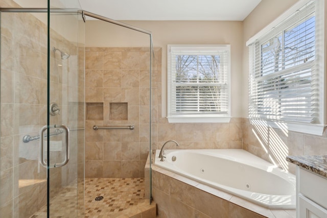 bathroom with a whirlpool tub, a shower stall, and vanity