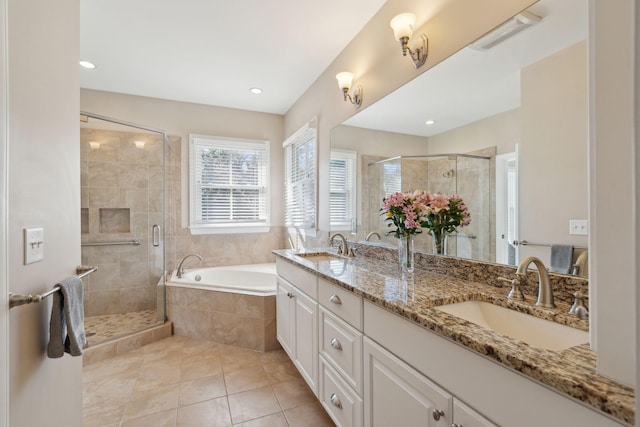 full bathroom featuring a garden tub, a stall shower, tile patterned flooring, and a sink