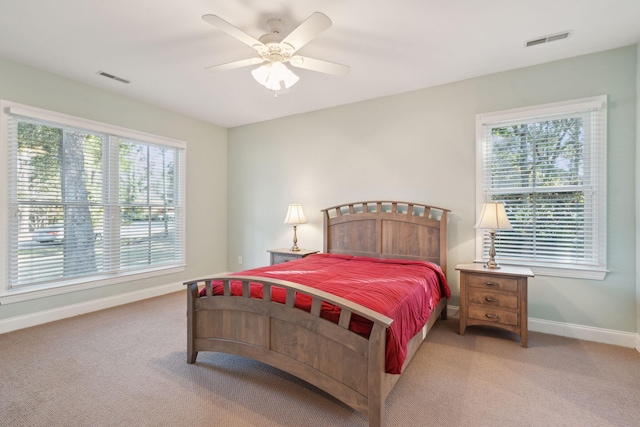 bedroom with multiple windows, carpet, and visible vents