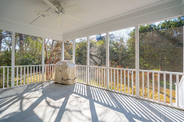 unfurnished sunroom featuring a ceiling fan