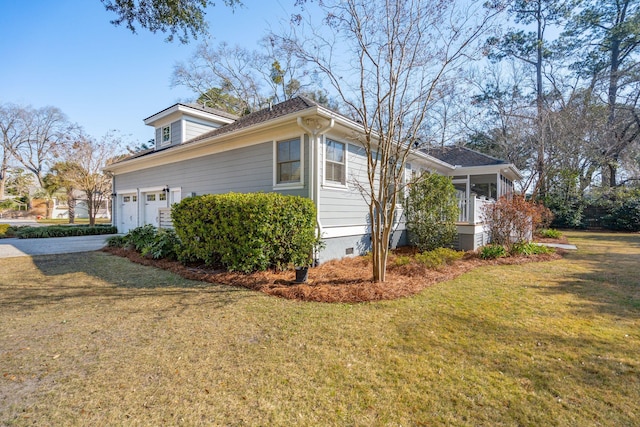 view of property exterior with crawl space, driveway, and a lawn