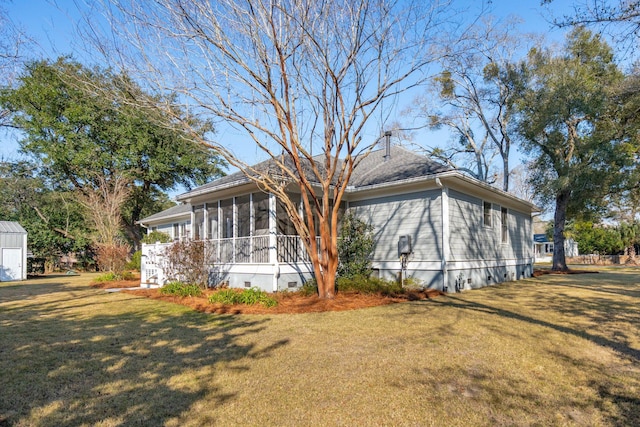 view of front of home featuring a front yard, a sunroom, and crawl space