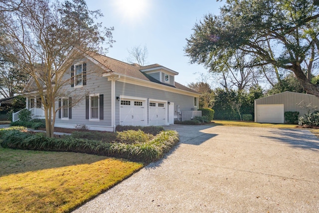 view of property exterior featuring driveway, a yard, and an attached garage