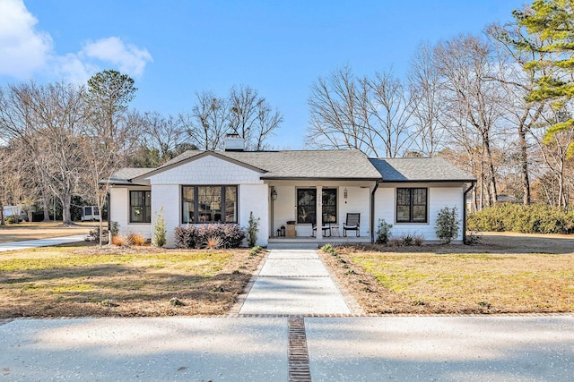 view of front of home with a porch and a front lawn