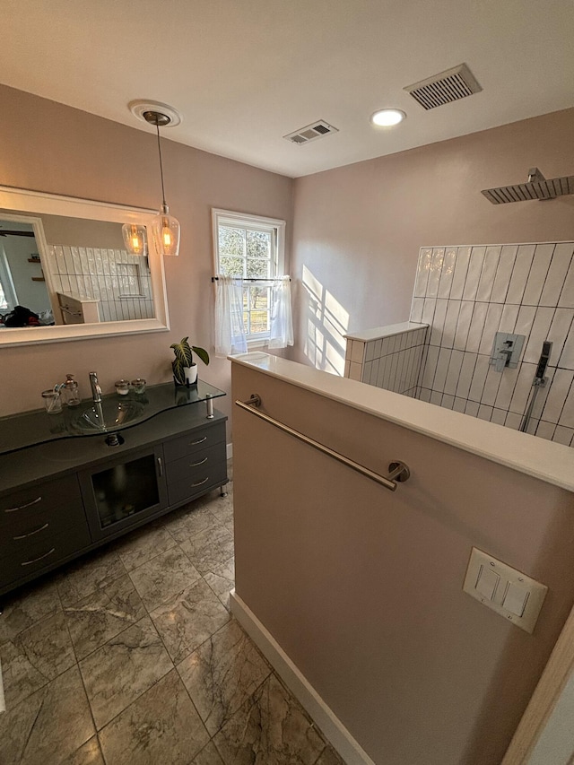 hallway featuring marble finish floor, visible vents, and a sink