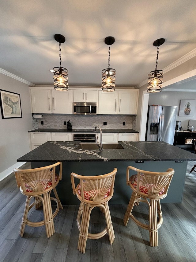 kitchen featuring stainless steel appliances, dark wood-type flooring, white cabinets, decorative backsplash, and crown molding