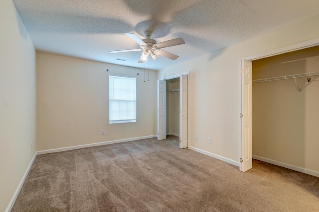 6280 Rolling Fork Rd Unit 302, North Charleston, SC 29406 - unfurnished bedroom featuring two closets, carpet floors, ceiling fan, and a textured ceiling