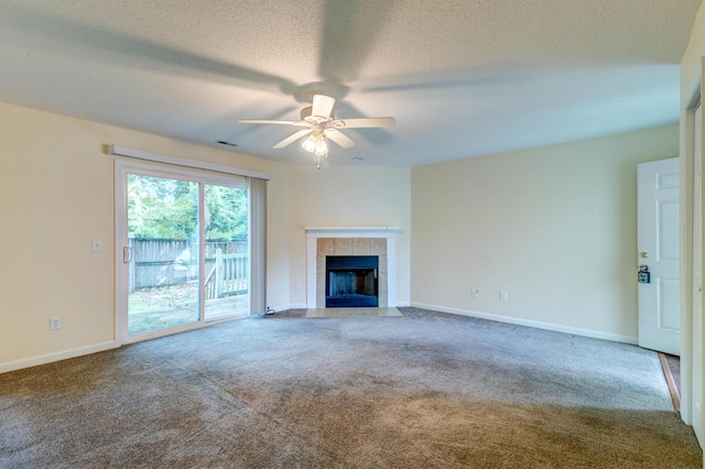 6280 Rolling Fork Rd Unit 302, North Charleston, SC 29406 - unfurnished living room featuring carpet, a ceiling fan, a tiled fireplace, and a textured ceiling