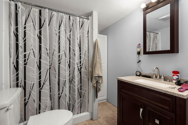 bathroom with walk in shower, vanity, toilet, and tile patterned flooring